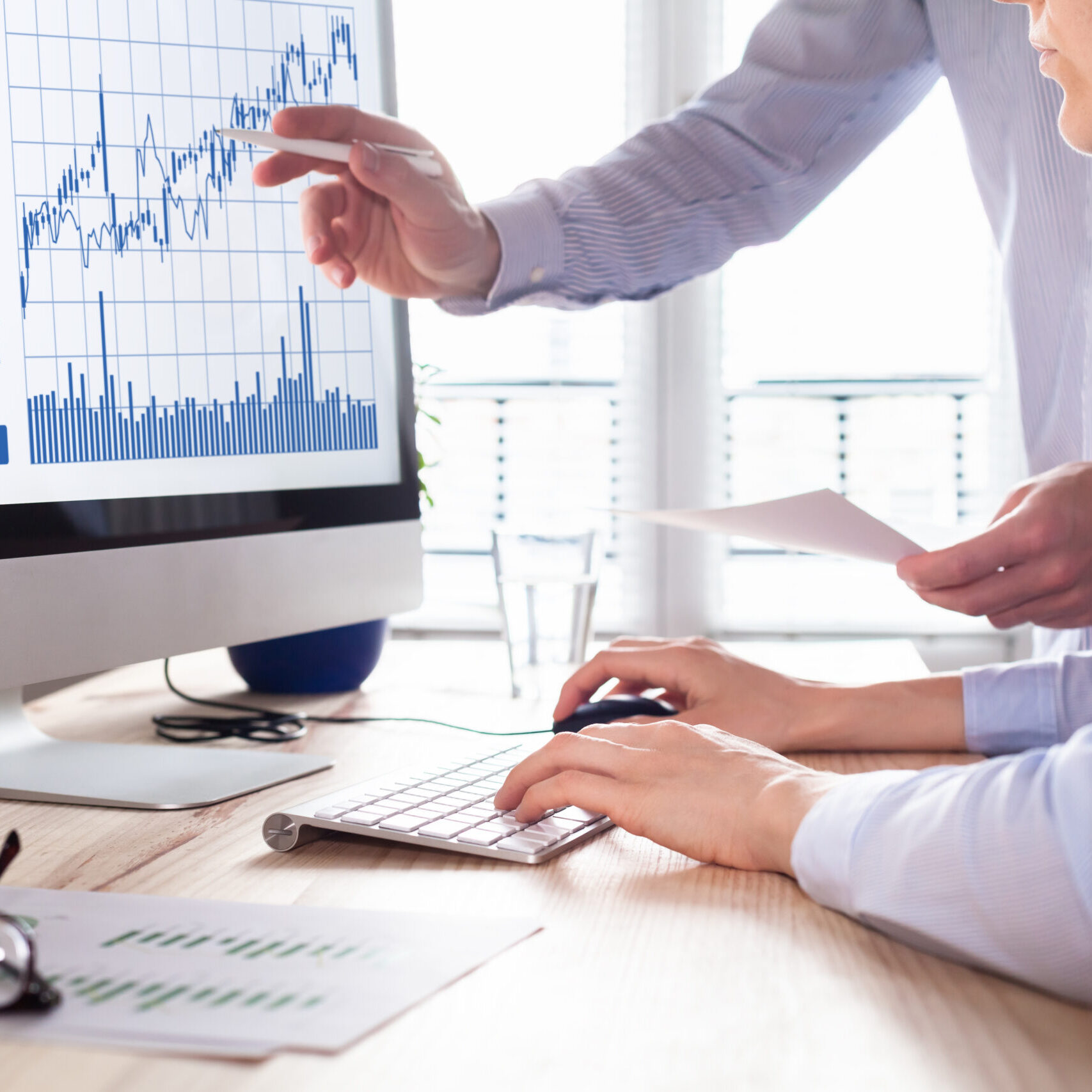 Team of traders working with forex (foreign exchange) trading charts and graphs on computer screen, concept about stock market investment, finance, selling and buying